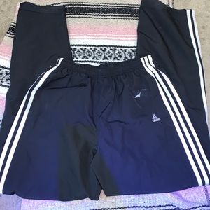 Black track pants with white stripes down legs